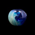 Swirling blue and green glass orb, likely a cannabis smoking accessory.