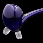 Purple glass pipe with clear footers against a black background.