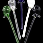 Assortment of colorful glass smoking pipes on a black background.