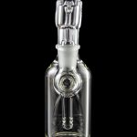 Clear glass bubbler water pipe with intricate design, reflecting on a black surface.