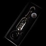 Glass oil rig with bubbler and dome, isolated on black.