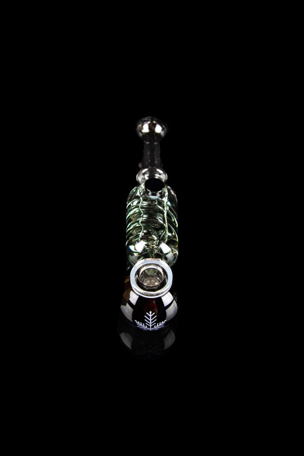 Glass cannabis oil rig with intricate green and white detailing, displayed against a black background.