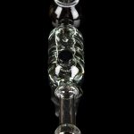 Glass bubbler with green accents and red mouthpiece, isolated on black.