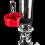 A glass bong with a red silicone attachment holding a lighter, showcasing intricate glasswork and a water chamber.