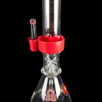 Red and clear glass water pipe (bong) with intricate percolator design, studio shot on black background.