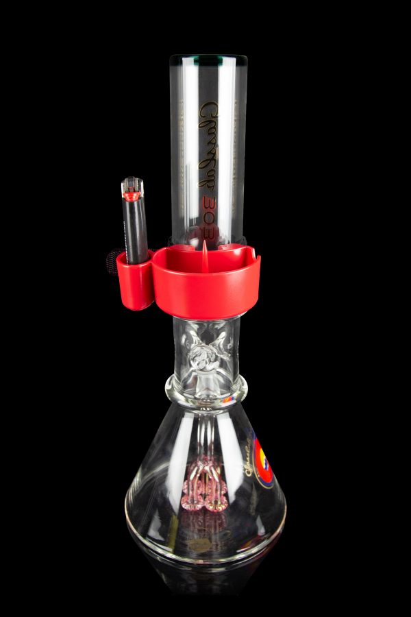 Red and clear glass water pipe (bong) with intricate percolator design, studio shot on black background.