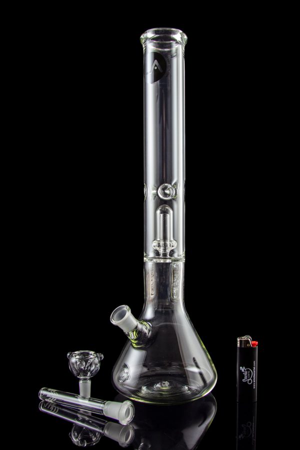 Clear glass bong with various attachments and accessories, reflecting on a black surface.