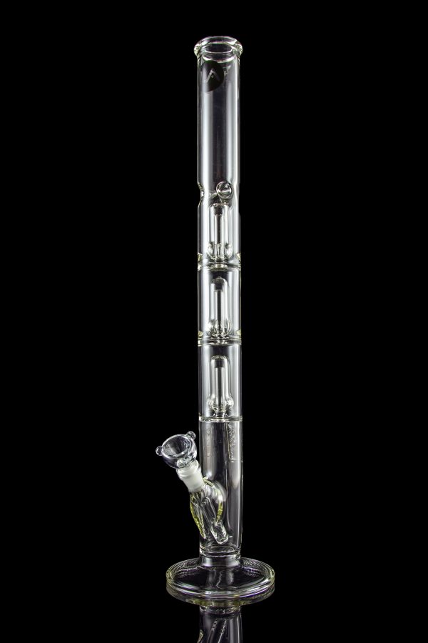 A tall, clear glass bong with multiple chambers and a glass bowl, isolated on a black background.