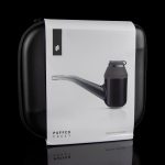 Puffco Proxy vaporizer in a closed white carrying case, reflecting on a glossy black surface.