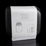 Closed black case for a “PROXY” modular vaporizer with line-drawing diagrams of components and a disclaimer against use with nicotine products, reflected on a glossy surface.