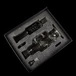 Glass cannabis water pipe and accessories neatly arranged in a black foam insert within a presentation box.
