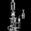 Clear glass water pipe (rig) with multiple chambers and a separate oil dome, isolated on a black background.