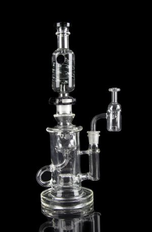 Clear glass water pipe (rig) with multiple chambers and a separate oil dome, isolated on a black background.