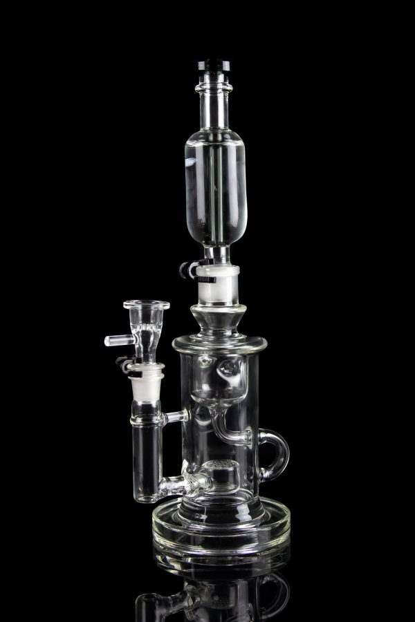 Clear glass water pipe (rig) with multiple chambers and attachments, isolated on a black background.