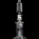 Clear glass dab rig with intricate percolator and bubbler components, isolated on a black background.