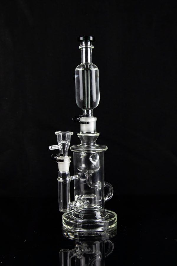 Clear glass water pipe (rig) with multiple chambers and a glass bowl, isolated on black.