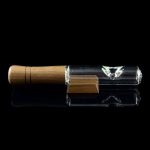 Wooden-tipped glass chillum with a second, empty chillum below, against a black background.