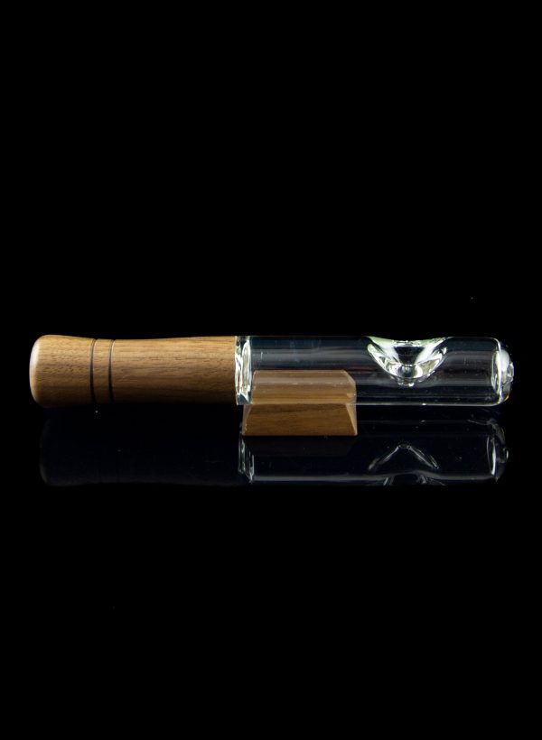 Wooden-tipped glass chillum with a second, empty chillum below, against a black background.