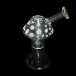 Glass mushroom-shaped dab rig with white polka dots, isolated on black.