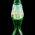 Green glass cannabis oil rig with milky white bubbles.