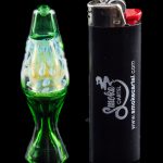 Green glass cannabis oil burner pipe with colorful swirls next to a black lighter branded with “Smoke Cartel.”