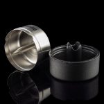 Silver and black cannabis concentrate extraction tool with a reflective surface.