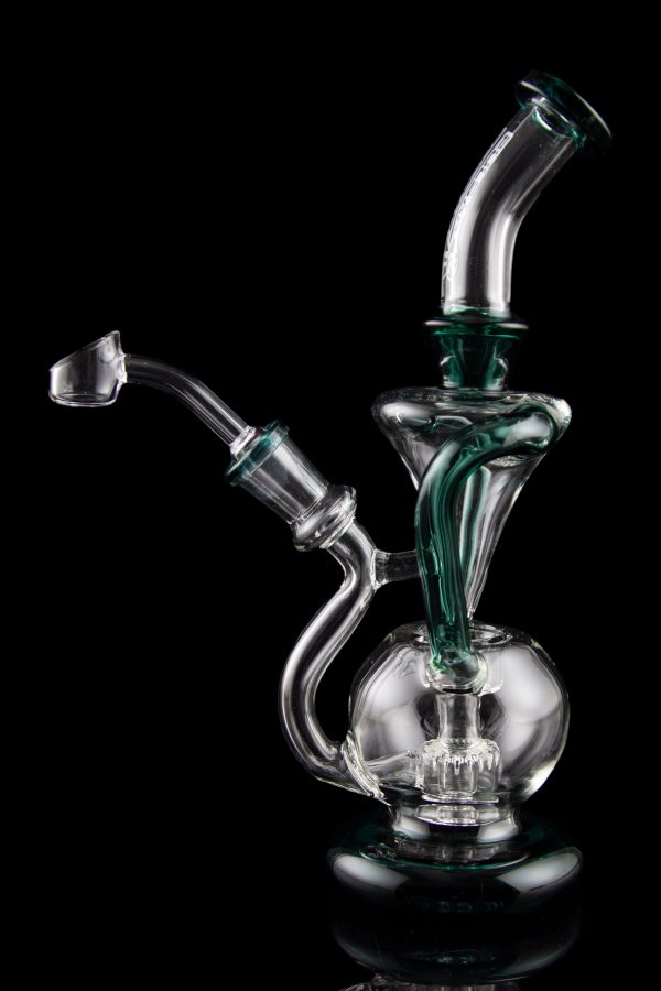 Clear glass water pipe (rig) with green accents, studio shot on black reflective surface.