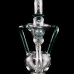 Green glass water pipe (rig) with bubbler and intricate design, isolated on a black background.