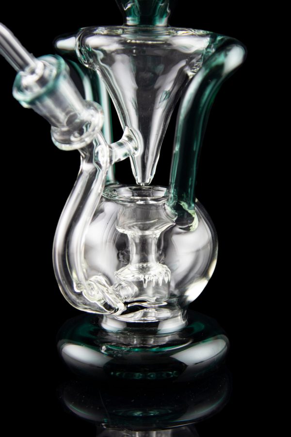 Clear glass water pipe (rig) with intricate bubbler design, isolated on black.