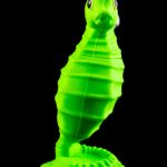 Neon green seahorse-shaped water pipe against a black background.