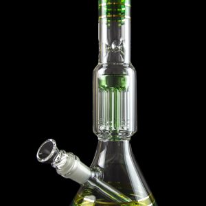 Green glass water pipe with multiple diffusion chambers, isolated on a black background.