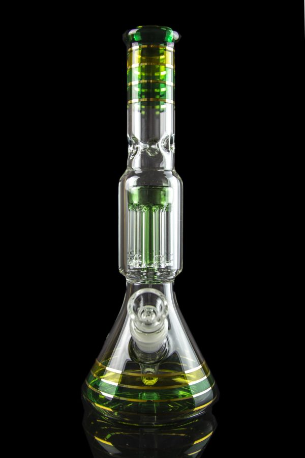 Glass water pipe (bong) with intricate percolators and green accents, isolated on a black background.
