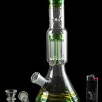 A vibrant green glass bong with a percolator base, alongside glass bowls and a lighter, set against a black background.