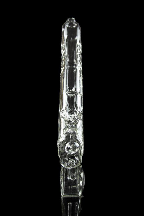 Clear glass bubbler with intricate sculpted design, reflected on a black surface.
