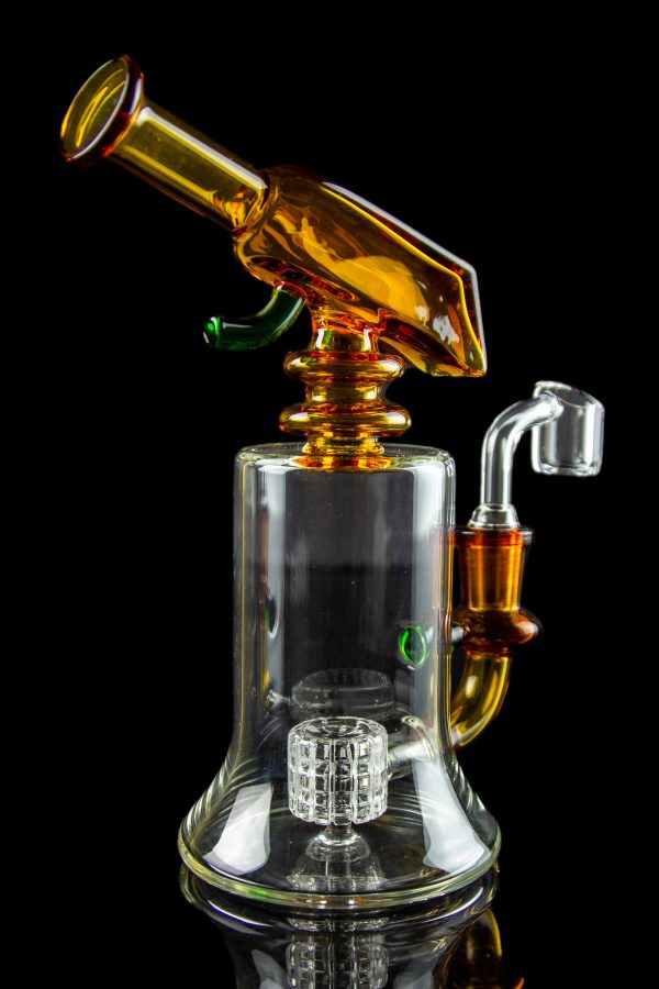 A colorful glass dab rig with a perc filter and quartz banger, isolated on a black background.