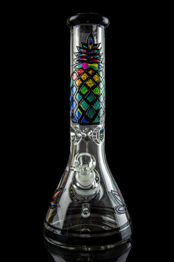 A colorful glass water pipe (bong) with a cannabis leaf design, isolated on a black background.