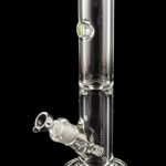 Clear glass water pipe (bong) with a flared base and ice catch, reflecting on a black surface.