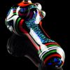 Hand-blown glass pipe with colorful stripes and speckled detailing, displayed against a black reflective surface.