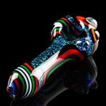 Hand-blown glass pipe with vibrant stripes and speckled accents, isolated on black.