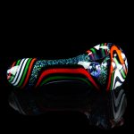 Colorful glass pipe with a reflective surface against a black background.