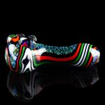 Colorful glass cannabis pipe with iridescent glitter accents, displayed on a reflective black surface.