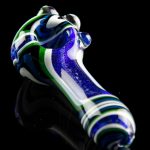 Hand-blown glass pipe with blue, white, and green swirl pattern against a black reflective surface.