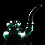 Emerald green glass water pipe against a black background.