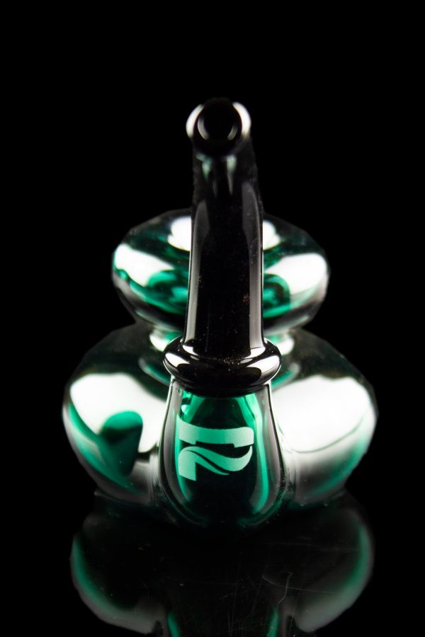Green and black glass dab rig with reflective surface, isolated on black.