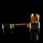 Amber glass cannabis oil rig with reflective surface.