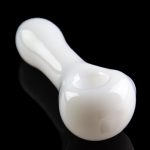 White glass pipe with a smooth, curved design, reflecting on a black surface.