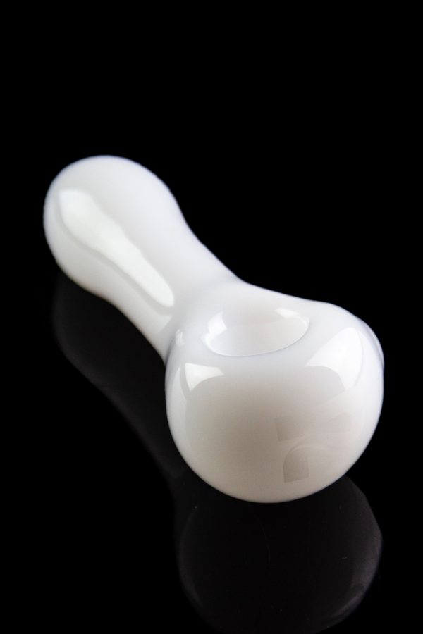 White glass pipe with a smooth, curved design, reflecting on a black surface.