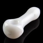 White glass pipe with a glossy finish, reflecting on a dark surface.