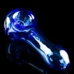 Blue glass pipe against a black background.
