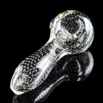 Glass cannabis pipe with speckled pattern and reflective surface.